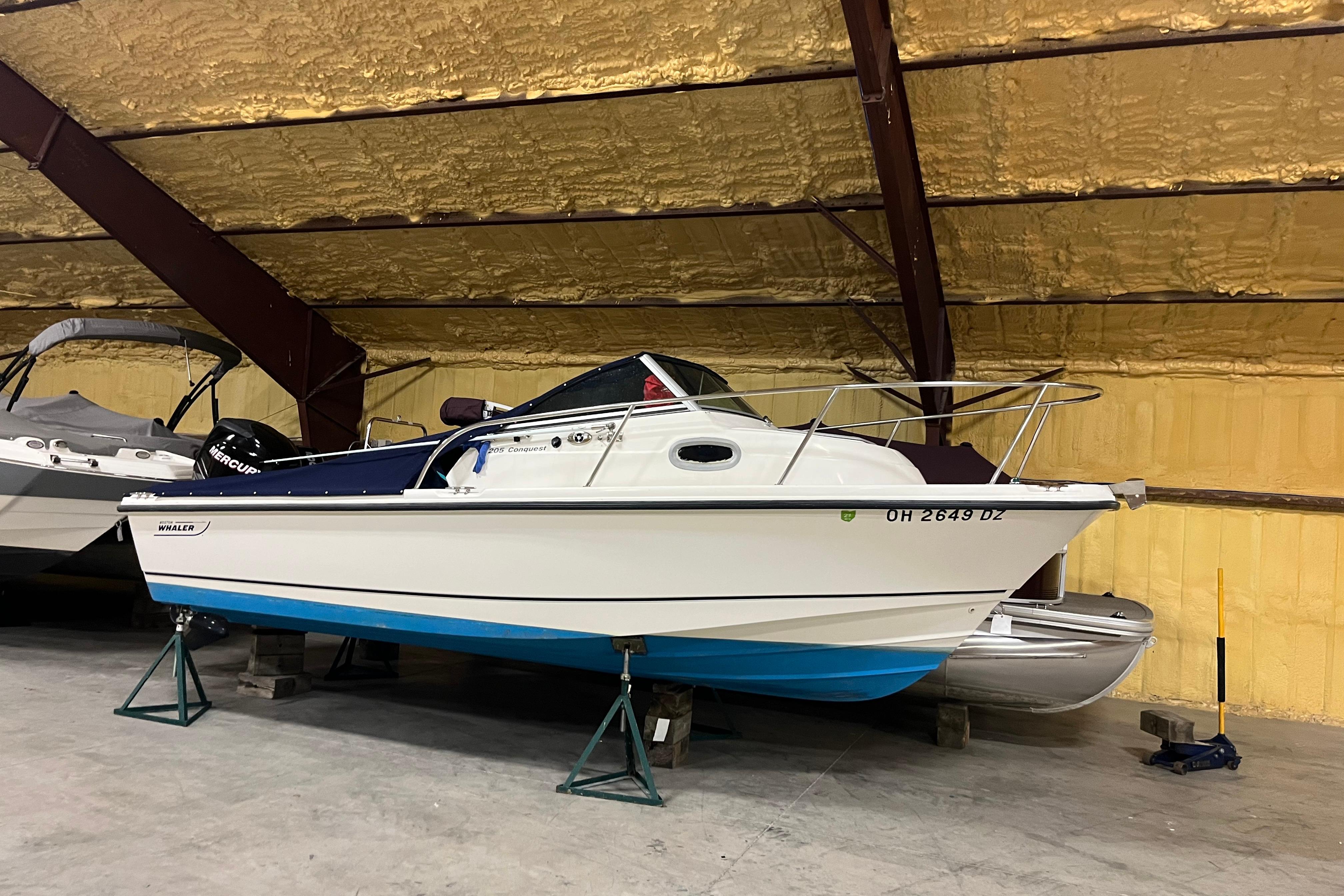 Boston Whaler 205 Conquest 2006 Boston Whaler 205 Conquest boat in indoor storage on stands.
