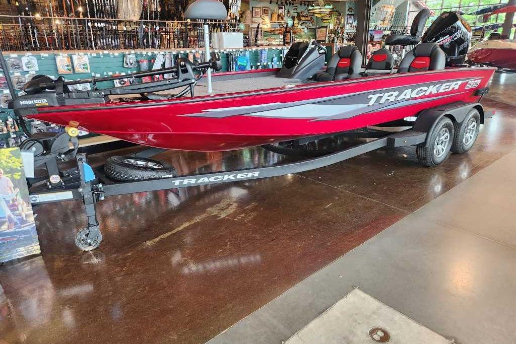 Tracker Savage 215 2025 Tracker Savage 215 boat in showroom, red exterior, on trailer.