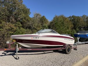 Tahoe Q4 SS 2008 Tahoe Q4 SS boat on trailer, parked outdoors with trees in the background.