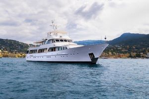 Feadship CARMAC VI Luxury yacht Feadship CARMAC VI, 1981 model, cruising near scenic coastline.