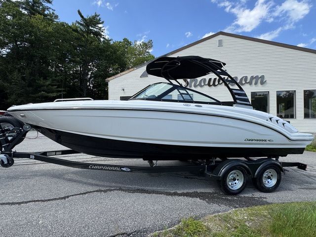 Chaparral 23 SSi 2025 Chaparral 23 SSi boat on trailer, parked outside showroom.