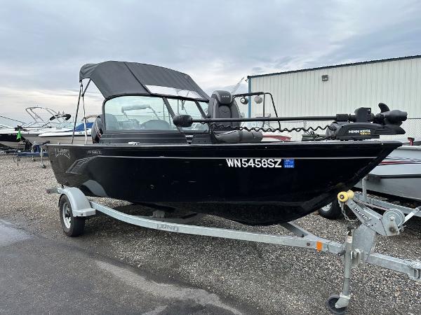 Lund 1650 Rebel XL 2022 Lund 1650 Rebel XL boat on trailer, black exterior, parked outdoors.