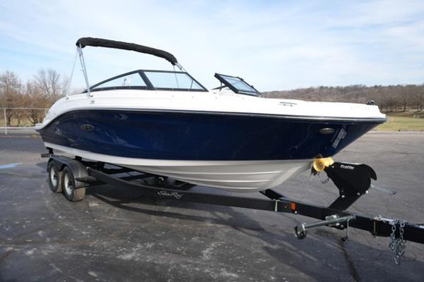 Sea Ray SPX 230 2025 Sea Ray SPX 230 boat on trailer, blue and white design, parked outdoors.