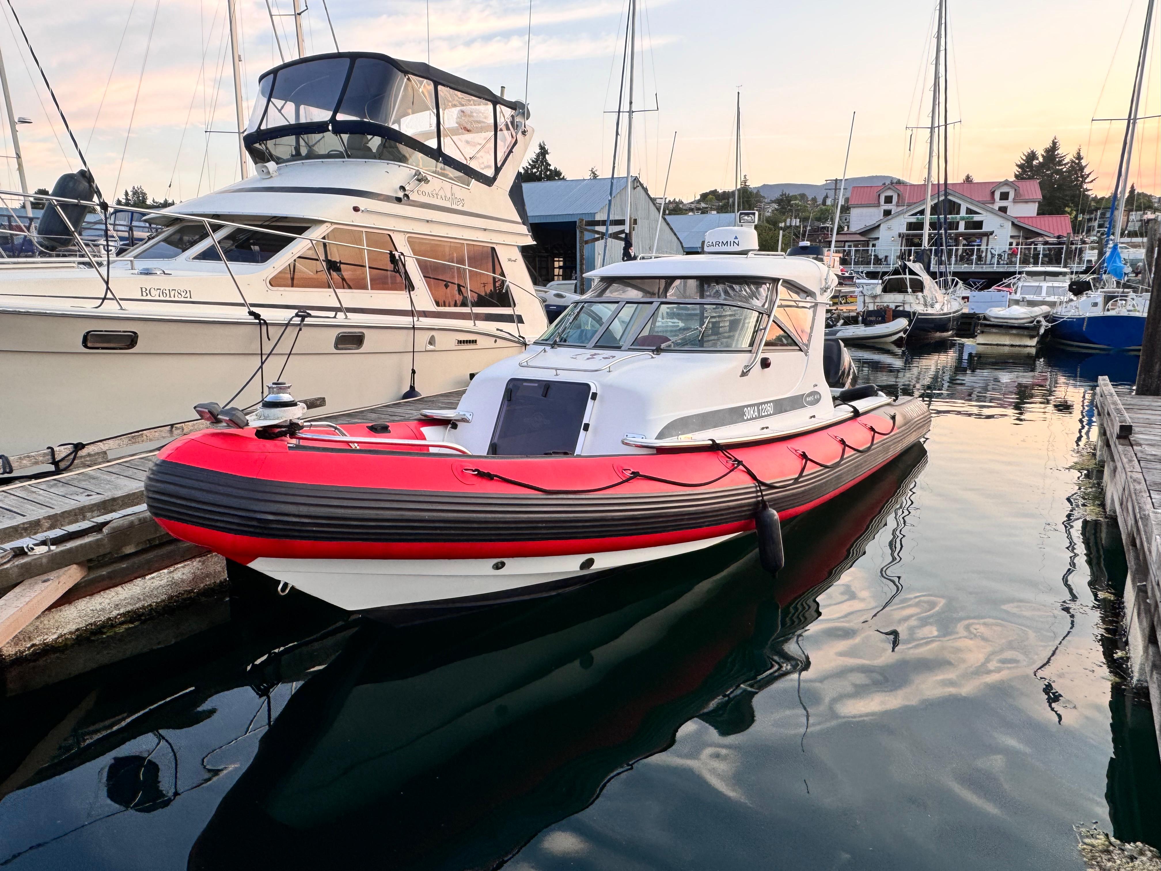 Protector Targa 28 2000 Protector Targa 28 boat docked in a marina, surrounded by other vessels.