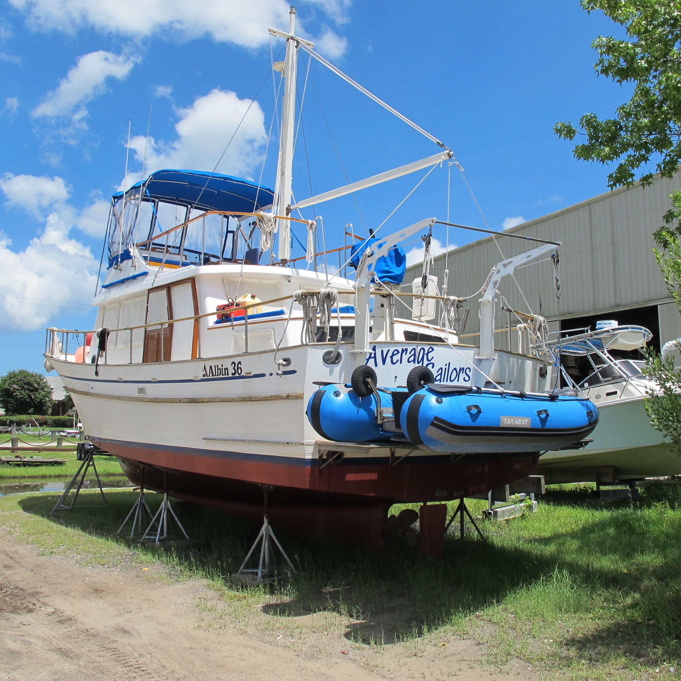 Albin Albin 36/ft 1981 Albin 36 boat on stands, blue canopy, clear sky background.