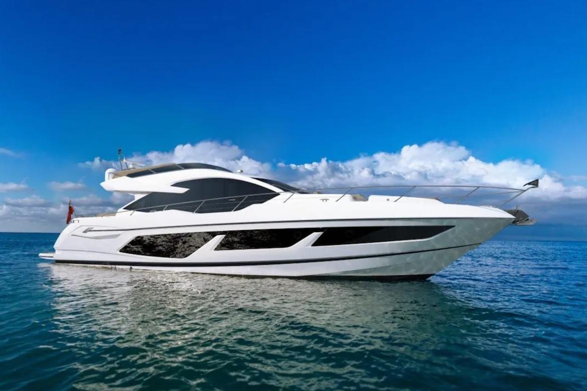 Sunseeker 74 Sport Yacht 2018 Sunseeker 74 Sport Yacht on open sea under clear blue sky.