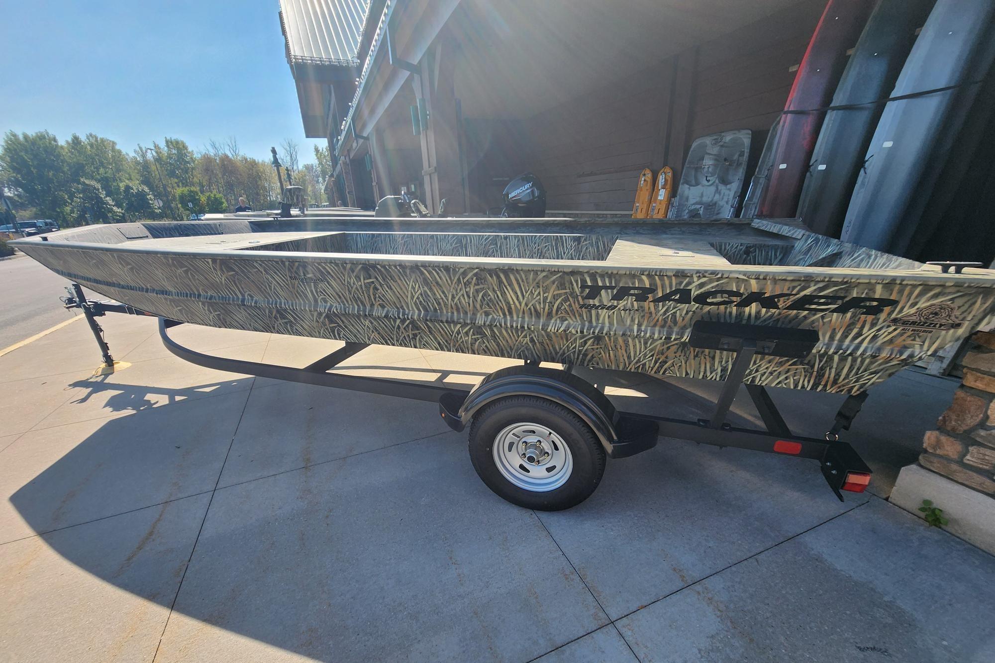 Tracker Grizzly 1860 Utility 2025 Tracker Grizzly 1860 Utility boat on trailer, parked outdoors.