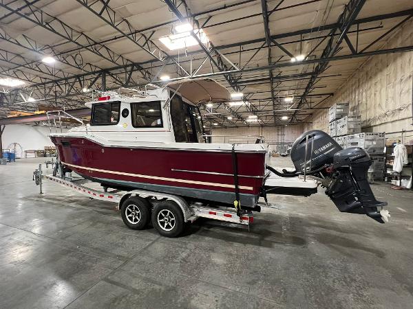 Ranger Tugs R-23 2017 Ranger Tugs R-23 boat on trailer in warehouse, featuring Yamaha outboard motor.