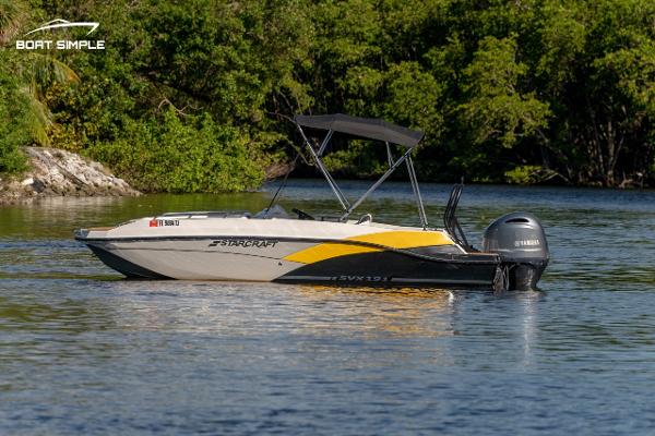 Starcraft SVX 191 OB 2022 Starcraft SVX 191 OB boat on calm water with lush greenery in the background.
