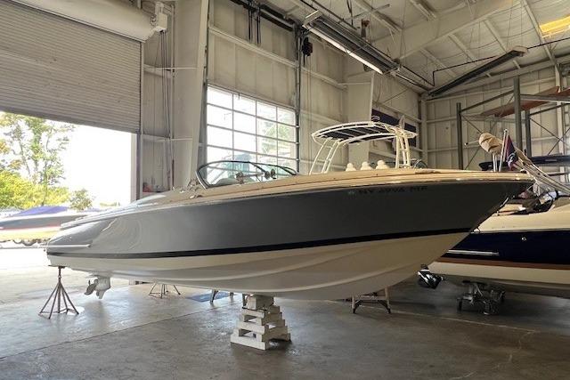 Chris-Craft Launch 27 2021 Chris-Craft Launch 27 boat in a spacious indoor storage facility.