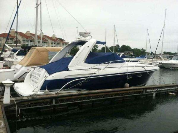 Formula 31 PC 2007 Formula 31 PC boat docked at marina with blue and white design.