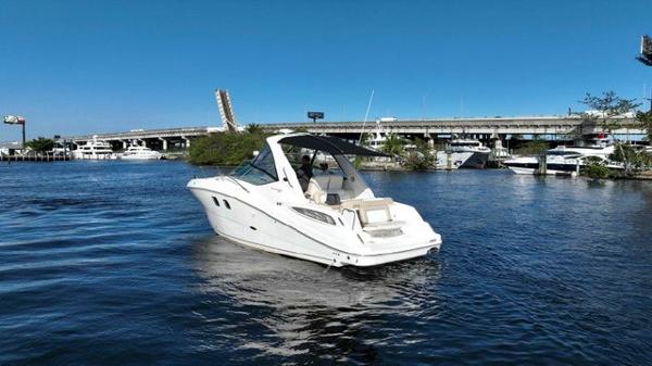 Sea Ray 330 Sundancer 2012 Sea Ray 330 Sundancer boat cruising on a sunny day near a bridge.