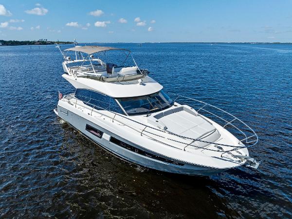 Prestige 460 2018 Prestige 460 yacht cruising on open water under a clear blue sky.