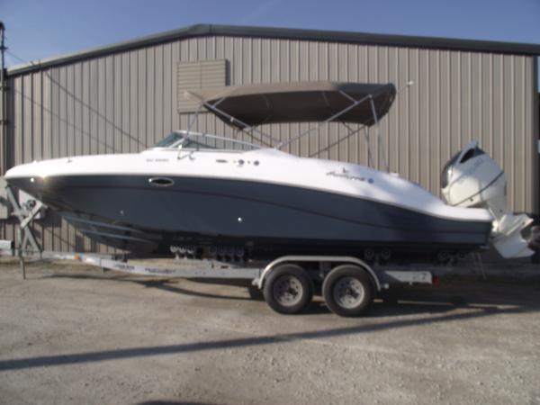 Hurricane SD 2690 2018 Hurricane SD 2690 boat on trailer, parked outside a metal building.