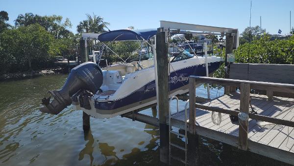 NauticStar 243DC Sport Deck 2017 NauticStar 243DC Sport Deck boat docked on a lift by the water.
