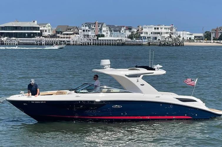 Sea Ray SLX 350 2019 Sea Ray SLX 350 boat cruising on water near coastal homes.