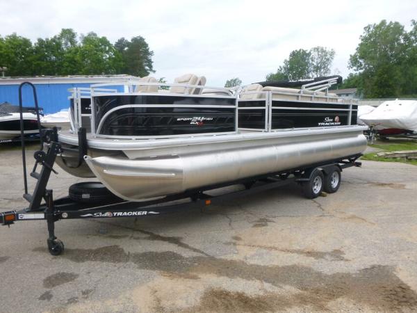 Sun Tracker Sportfish 24 XP3 2024 Sun Tracker Sportfish 24 XP3 pontoon boat on trailer, parked outdoors.