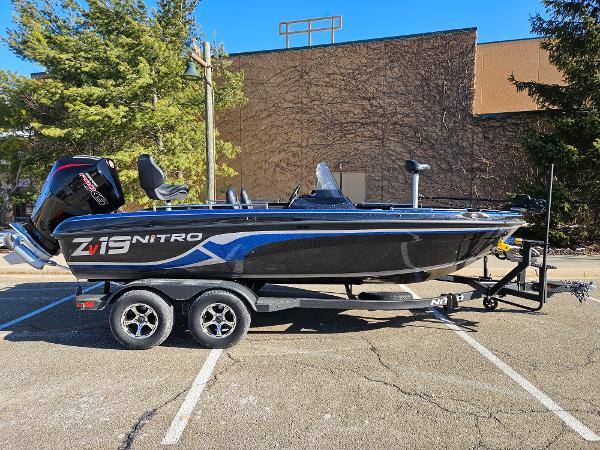 Nitro ZV19 2025 Nitro ZV19 boat on trailer in parking lot, side view.