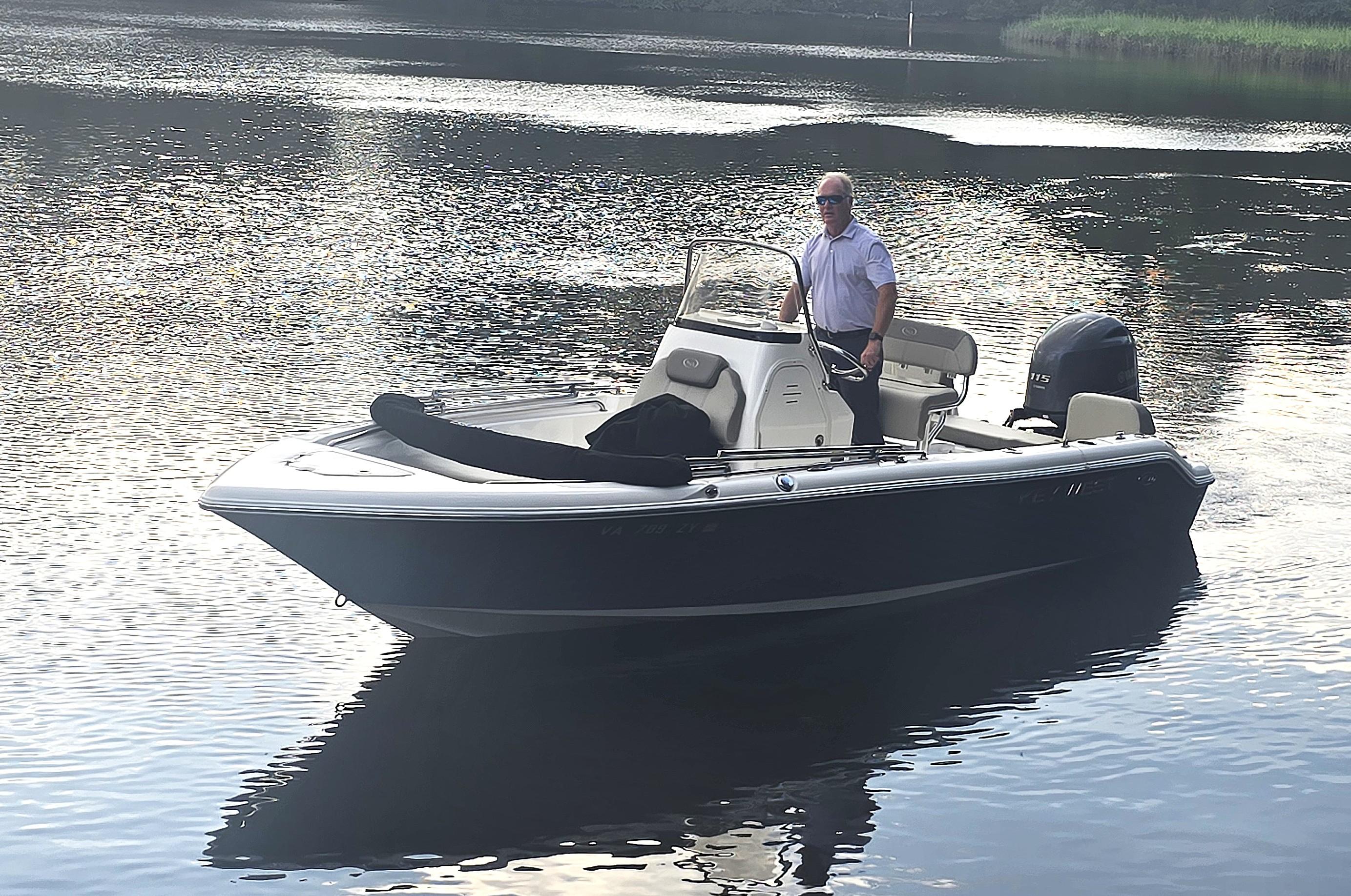 Key West 189 FS 2021 Key West 189 FS boat on calm water with a person standing at the helm.