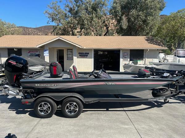 Ranger RT198P 2024 Ranger RT198P boat parked outside a building, featuring sleek design and dual-axle trailer.