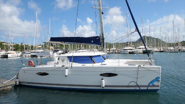 Fountaine Pajot Helia 44 2014 Fountaine Pajot Helia 44 catamaran docked in a marina, surrounded by sailboats.