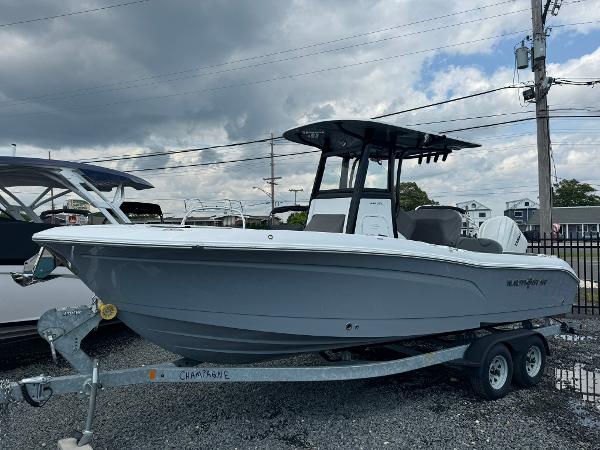 NauticStar 242L Offshore 2025 NauticStar 242L Offshore boat on trailer under cloudy sky.