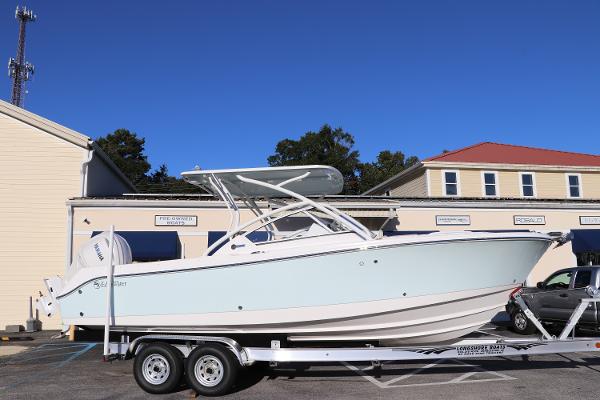 Edgewater 248 CX 2025 Edgewater 248 CX boat on trailer, parked outside buildings.