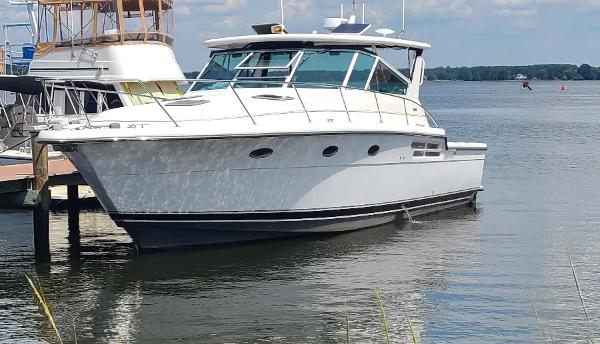 Tiara Yachts 4100 Open 1999 Tiara Yachts 4100 Open docked on calm water under a clear sky.