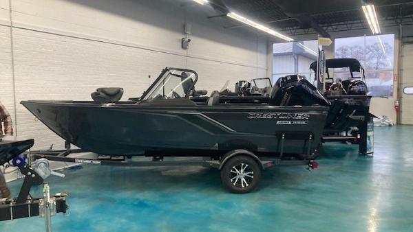 Crestliner 1650 Hawk 2025 Crestliner 1650 Hawk boat in showroom, side view.