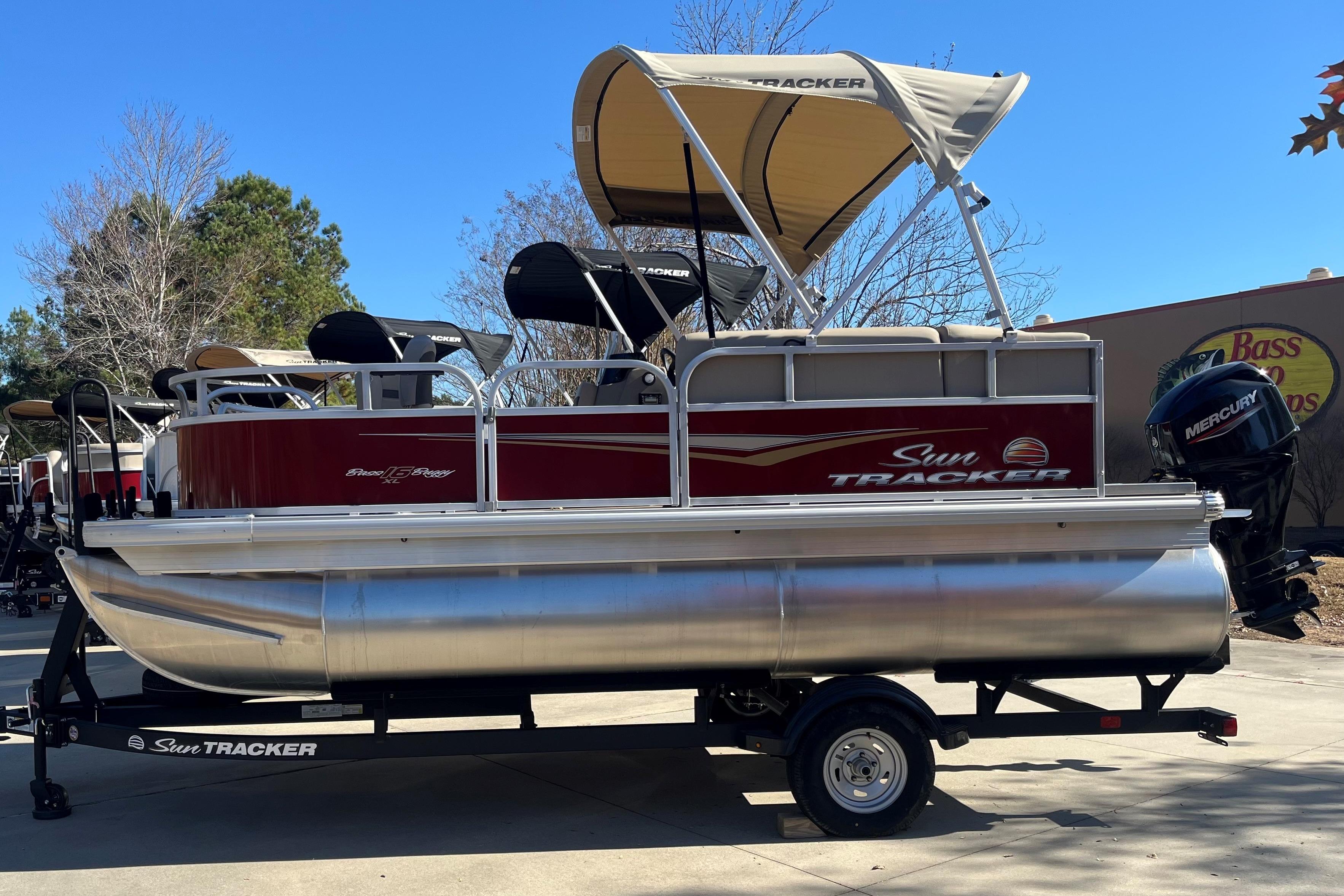 Sun Tracker Bass Buggy 16 XL Select 2025 Sun Tracker Bass Buggy 16 XL Select pontoon boat on trailer, outdoors.