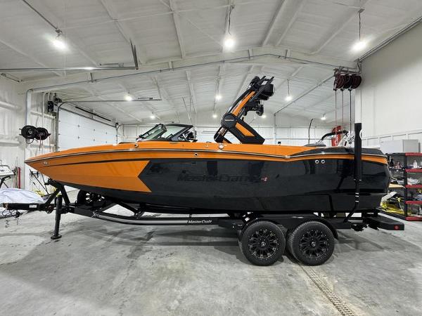 MasterCraft XStar S 2024 MasterCraft XStar S boat in a garage, orange and black color scheme.