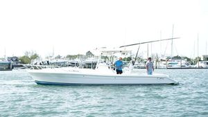 Strike 35 A 2016 Strike 35 boat on water with two people onboard, near a marina.