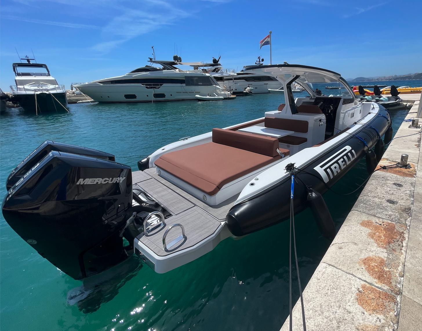 Pirelli 35 2023 Pirelli 35 boat docked, featuring Mercury engines, in a sunny marina setting.
