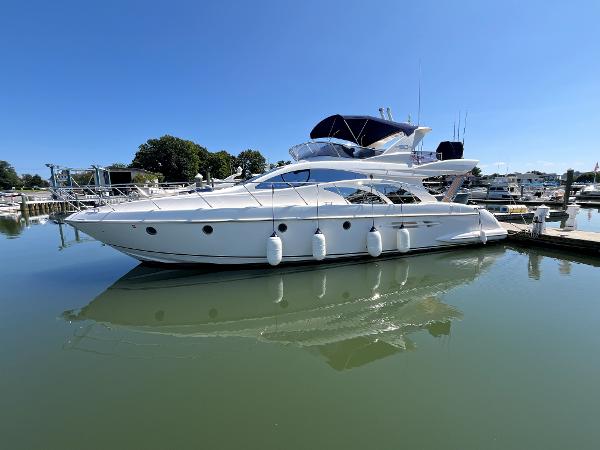 Azimut 50 2010 Azimut 50 yacht docked in a serene marina under clear blue skies.