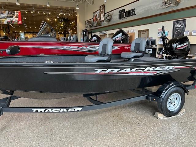 Tracker Super Guide V-16 T 2025 Tracker Super Guide V-16 T boat displayed in showroom with trailer.