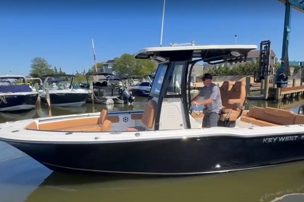 Key West 239 FS 2026 Key West 239 FS boat in marina, featuring sleek design and comfortable seating.