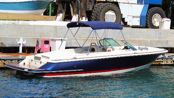 Chris-Craft Launch 27 2022 Chris-Craft Launch 27 boat docked, featuring a sleek design and blue canopy.