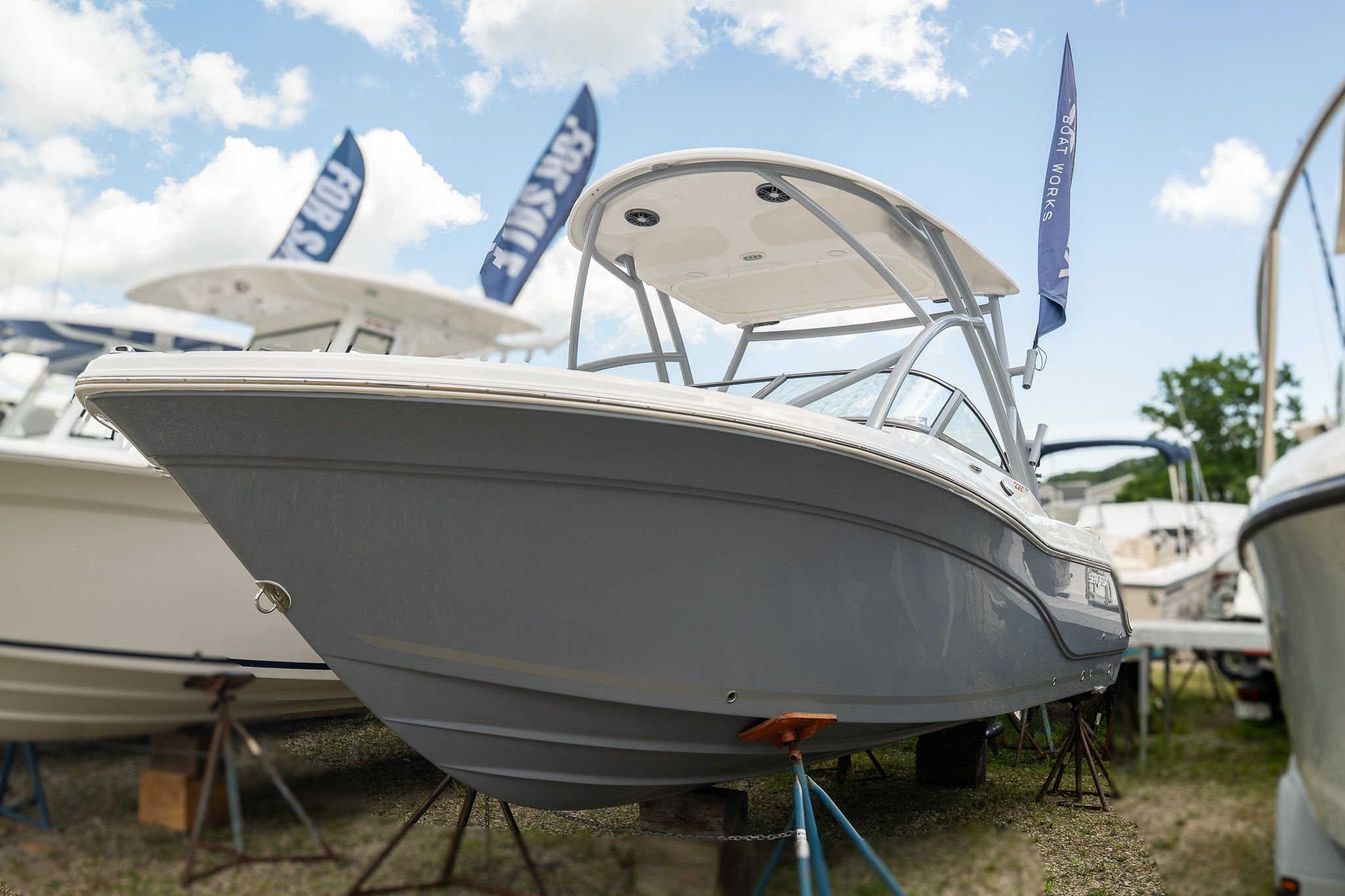 Sea Fox 228 Traveler 2026 Sea Fox 228 Traveler boat displayed outdoors with flags and blue sky.