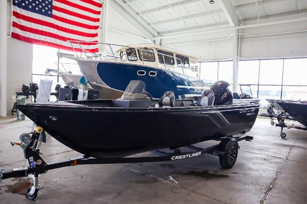 Crestliner 1750 Hawk SC 2025 Crestliner 1750 Hawk SC boat displayed indoors with American flag backdrop.