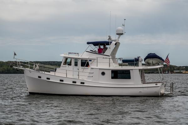 Krogen 44 AE 2027 Krogen 44 AE yacht on calm water, featuring sleek design and modern amenities.