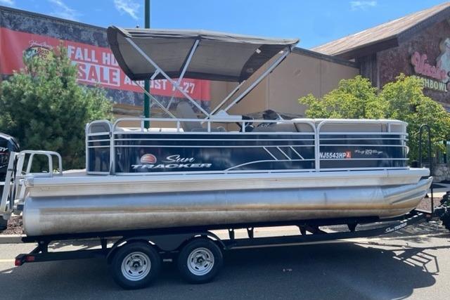 Sun Tracker Party Barge 20 DLX 2022 Sun Tracker Party Barge 20 DLX pontoon boat on trailer, outdoor setting.