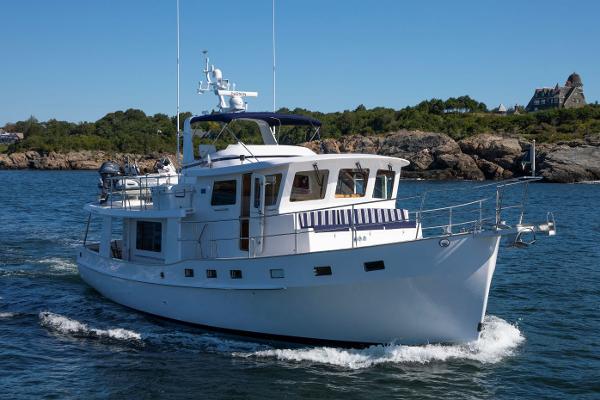Krogen 48 AE 2027 Krogen 48 AE yacht cruising on a scenic coastal waterway.
