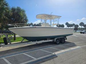 Pursuit 2600 Center Console 1995 Pursuit 2600 Center Console boat on trailer in sunny parking lot.