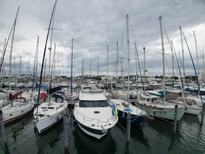 Beneteau Antares 42 Boats docked in a marina, featuring a 2011 Beneteau Antares 42 under cloudy skies.