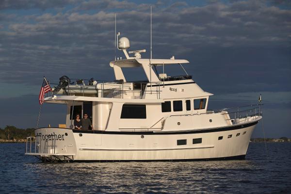 Krogen 50 Open 2027 Krogen 50 Open yacht cruising on calm waters under a cloudy sky.