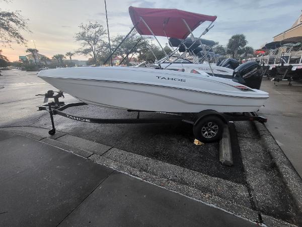 Tahoe T18 2025 Tahoe T18 boat on trailer, parked outdoors, with a red canopy.