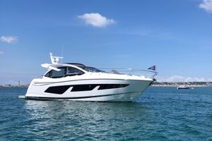 Sunseeker Predator 50 2020 Sunseeker Predator 50 yacht on calm blue water under clear sky.