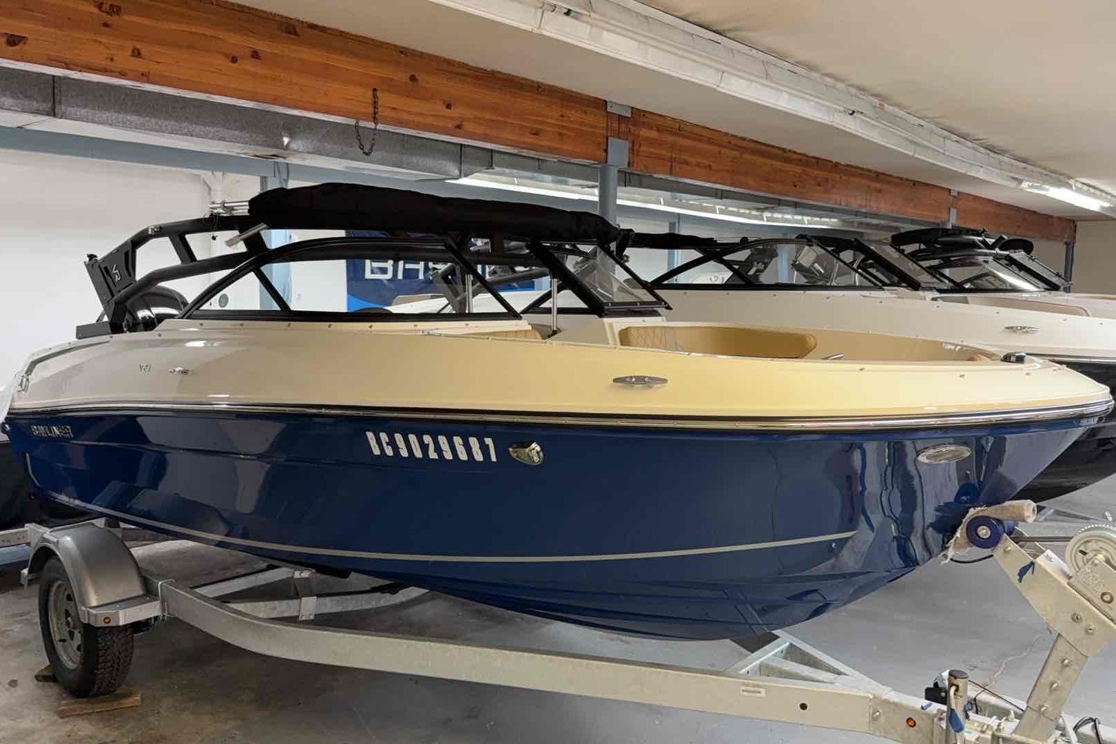 Bayliner VR4OB 2024 Bayliner VR4OB boat in showroom, blue hull, on trailer.