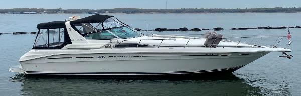 Sea Ray 400 Express Cruiser 1993 Sea Ray 400 Express Cruiser on calm water, side view.