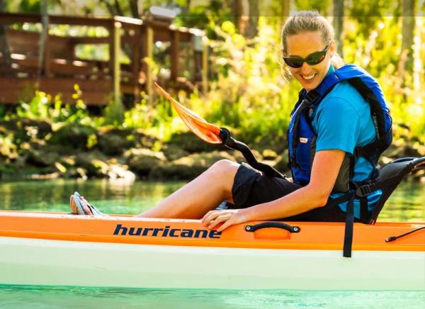 Hurricane Kayaks Skimmer 116 First Class Woman kayaking in a 2023 Hurricane Skimmer 116 First Class kayak on a sunny day.